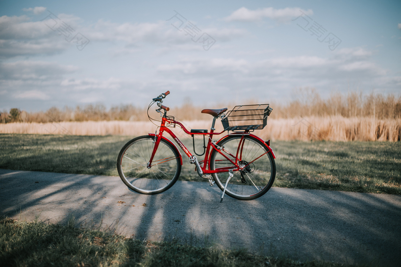 白天在草地上的红色通勤自行车