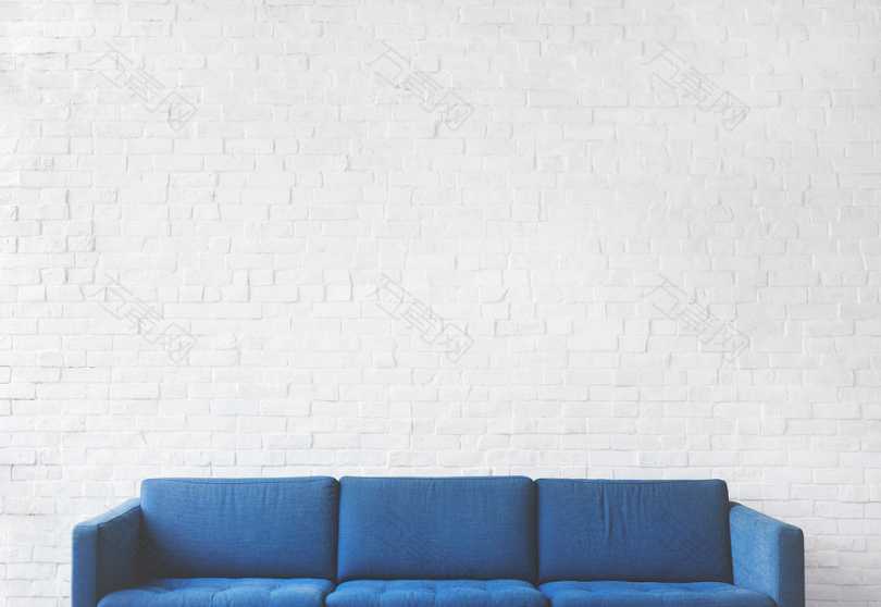 蓝色三椅沙发靠近白砖墙